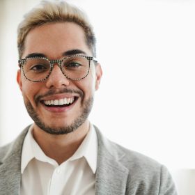 Young business man man smiling on camera - Main focus on mouth